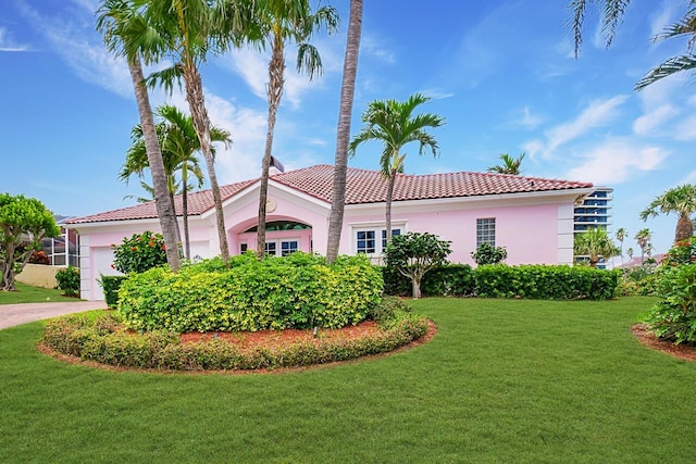 mediterranean / spanish house with a front yard