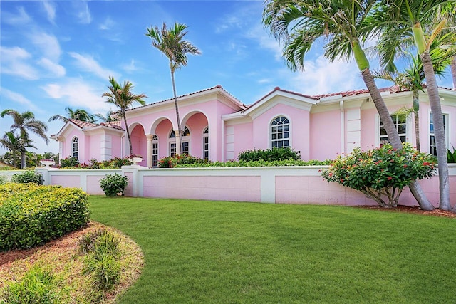 mediterranean / spanish-style home featuring a front lawn