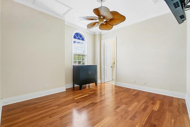 spare room with crown molding, hardwood / wood-style floors, and ceiling fan