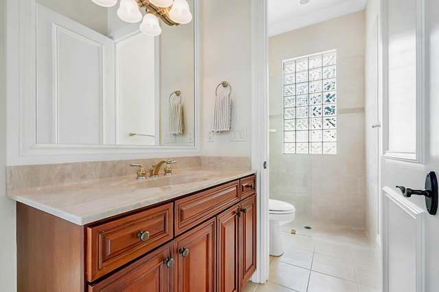 bathroom with tile patterned floors, vanity, a chandelier, and toilet