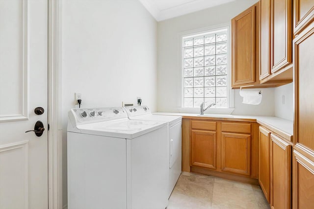 clothes washing area with separate washer and dryer, sink, cabinets, and ornamental molding