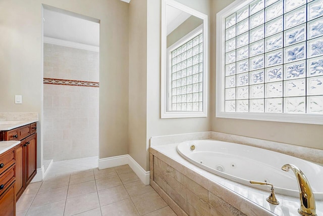 bathroom featuring plus walk in shower, vanity, tile patterned floors, and a healthy amount of sunlight