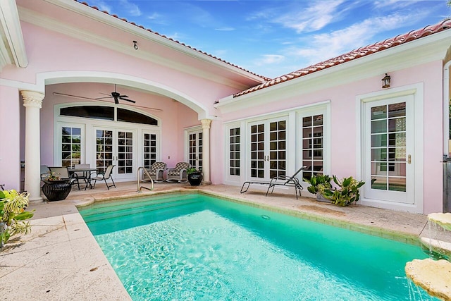 view of pool with a patio area, ceiling fan, and french doors