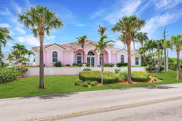 mediterranean / spanish-style home with a front yard