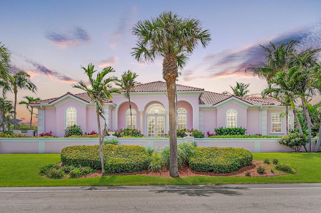 mediterranean / spanish-style house featuring a lawn