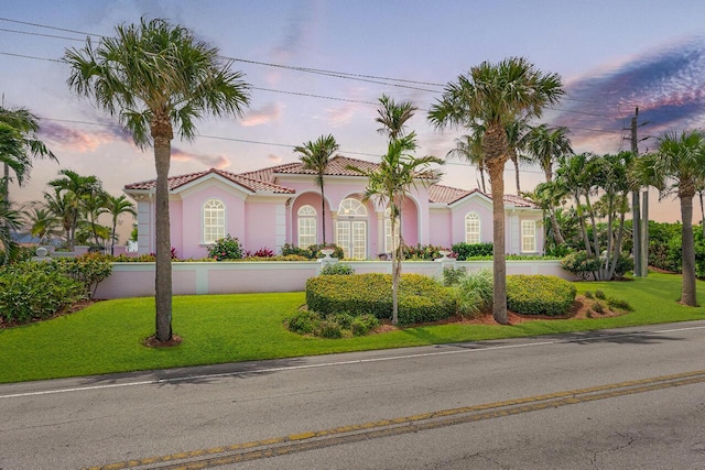 mediterranean / spanish-style house with a yard