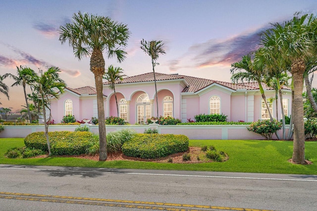 mediterranean / spanish house with a lawn