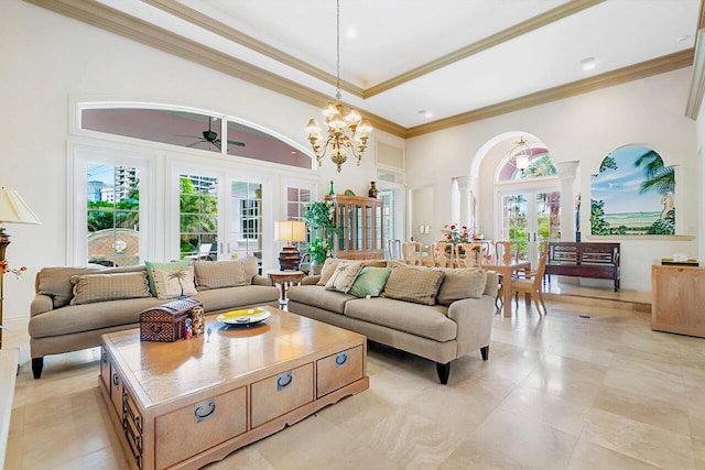 living room with crown molding, french doors, ceiling fan with notable chandelier, and a high ceiling