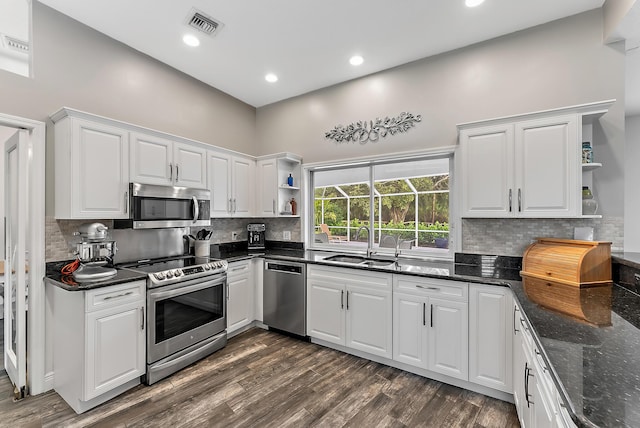 kitchen featuring sink, white cabinetry, stainless steel appliances, and dark wood-type flooring