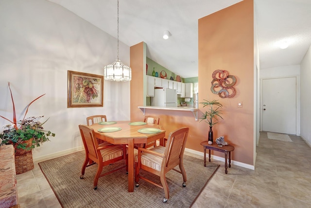 dining area with light tile patterned floors and high vaulted ceiling