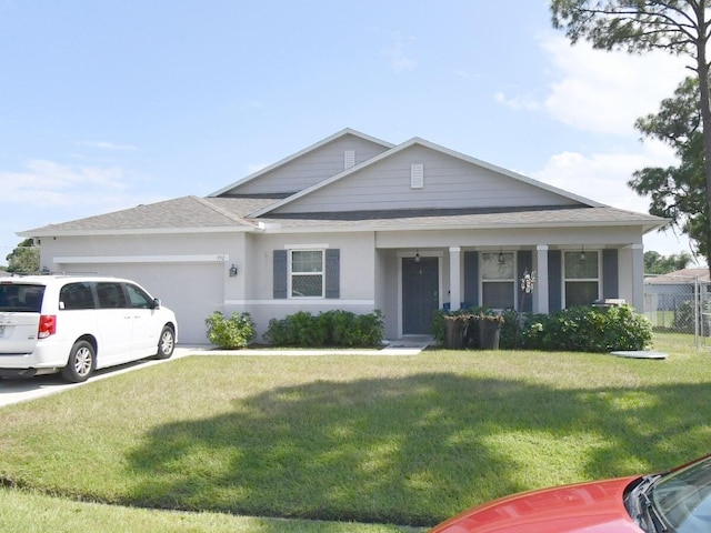 view of front of property featuring a front yard and a garage