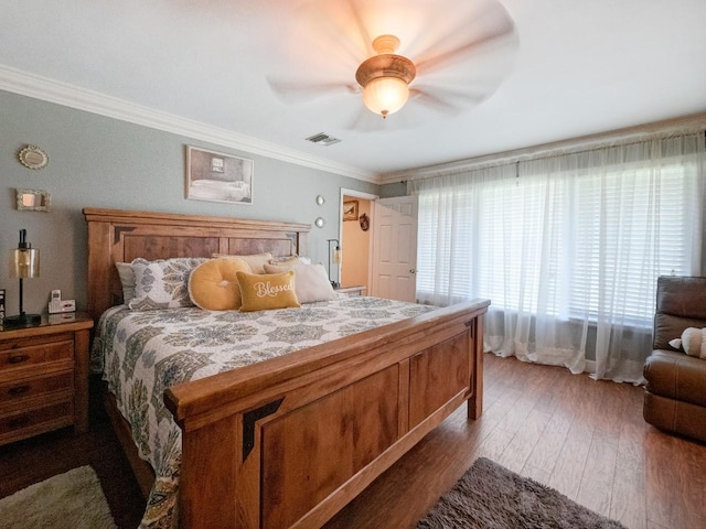 bedroom featuring hardwood / wood-style floors, ceiling fan, and ornamental molding