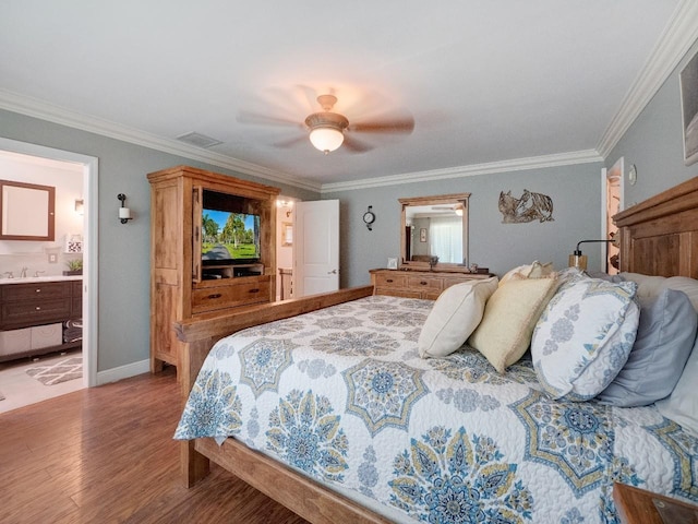 bedroom with ceiling fan, crown molding, connected bathroom, and light hardwood / wood-style flooring