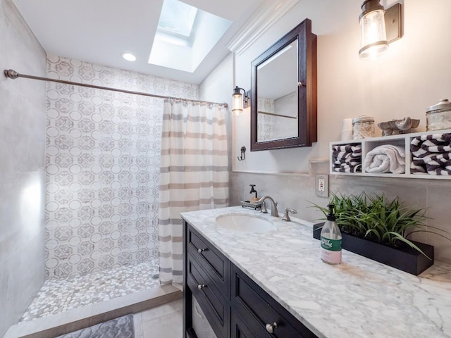 bathroom with a skylight, a shower with curtain, and vanity