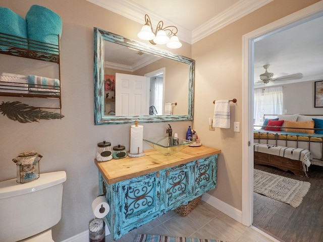 bathroom featuring vanity, toilet, ceiling fan, and ornamental molding