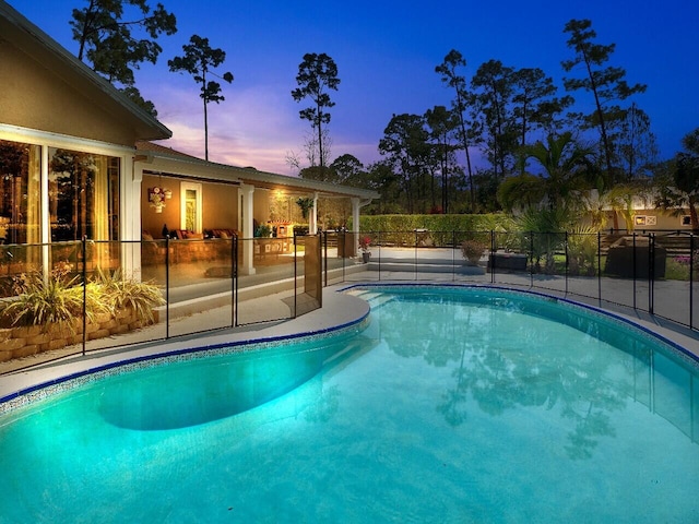 view of pool at dusk