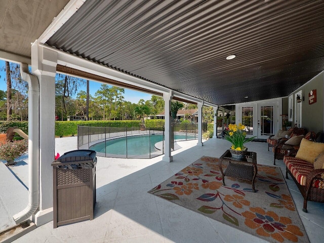 view of swimming pool featuring outdoor lounge area, a patio, and french doors