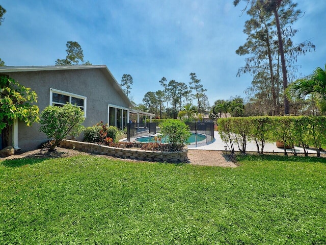 view of yard with a fenced in pool