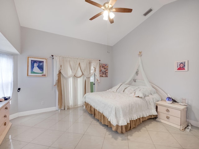 tiled bedroom with ceiling fan and vaulted ceiling