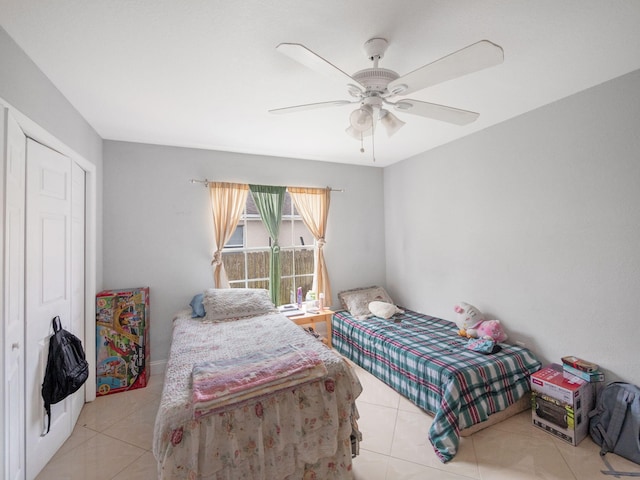 tiled bedroom with a closet and ceiling fan