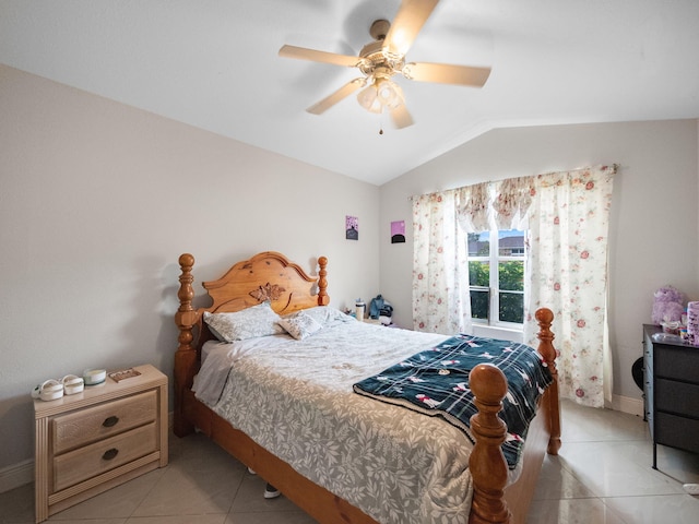 bedroom featuring ceiling fan, light tile patterned floors, and lofted ceiling