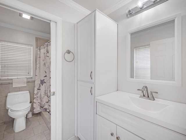 bathroom featuring tile patterned floors, vanity, toilet, and crown molding