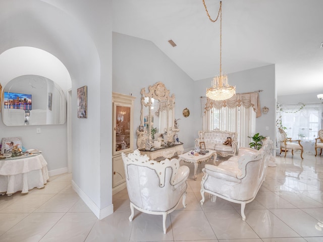 tiled living room with a chandelier and vaulted ceiling