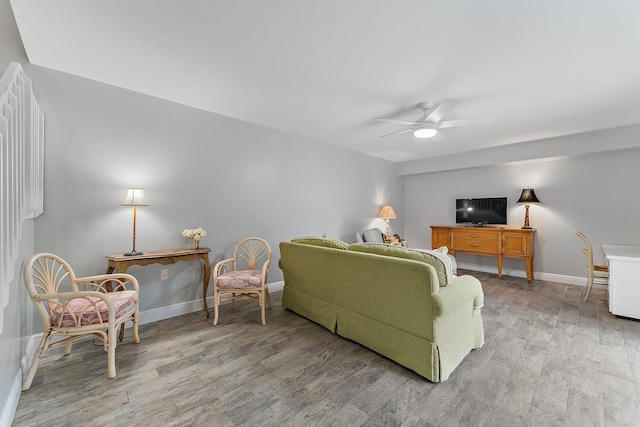 living room with hardwood / wood-style flooring and ceiling fan