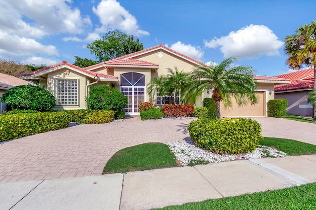 mediterranean / spanish-style home with a garage