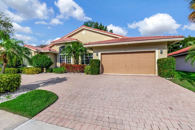 mediterranean / spanish home featuring a garage