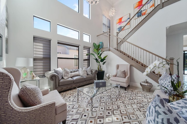 living room with a high ceiling and an inviting chandelier