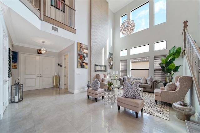 interior space featuring a towering ceiling, crown molding, and a chandelier