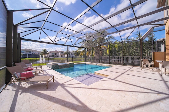 view of swimming pool with glass enclosure, an in ground hot tub, a water view, and a patio