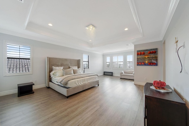 bedroom with a raised ceiling and crown molding