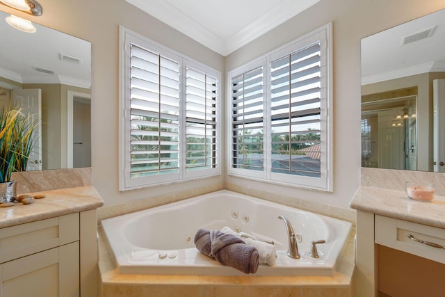 bathroom featuring vanity, ornamental molding, and tiled tub