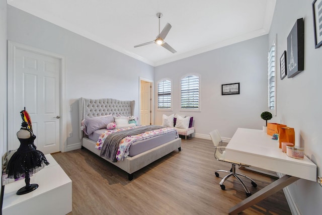 bedroom featuring hardwood / wood-style floors, ceiling fan, and ornamental molding