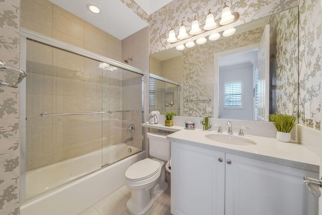 full bathroom with tile patterned floors, vanity, combined bath / shower with glass door, and toilet