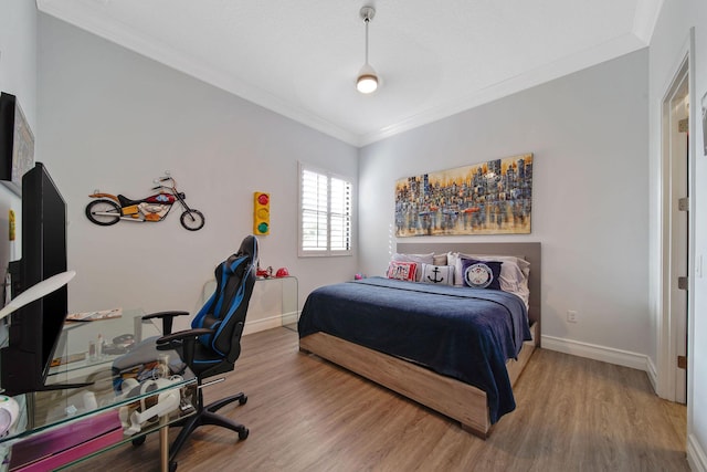 bedroom with crown molding and wood-type flooring