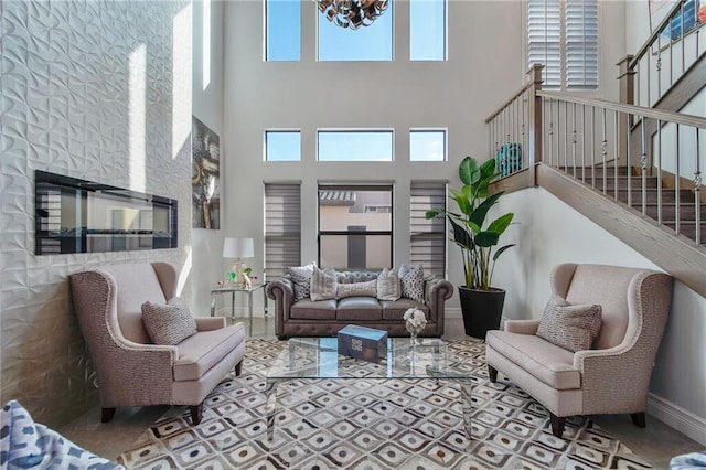 living room featuring a towering ceiling and a chandelier