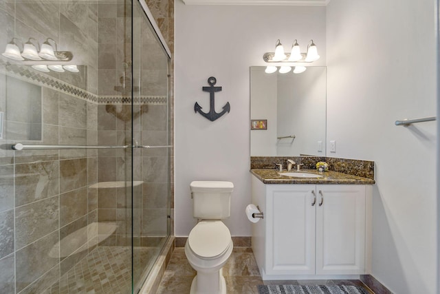 bathroom with vanity, a shower with shower door, and toilet