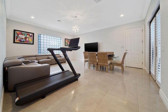 exercise area with light tile patterned floors, a notable chandelier, and ornamental molding