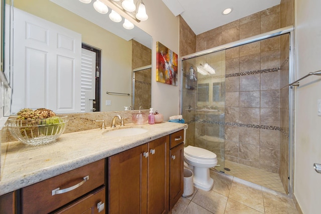 bathroom featuring tile patterned floors, walk in shower, vanity, and toilet