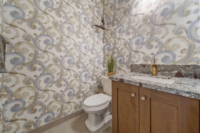 bathroom with tile patterned floors, vanity, and toilet