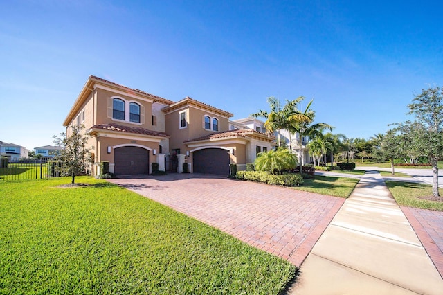 mediterranean / spanish house with a front yard and a garage