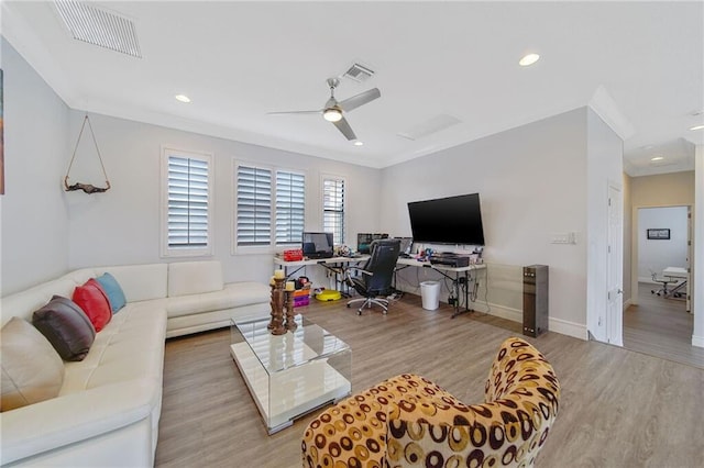 living room featuring ceiling fan, light hardwood / wood-style flooring, and ornamental molding