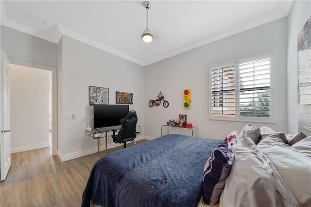 bedroom with crown molding and light hardwood / wood-style flooring