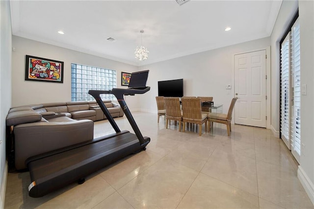 workout area featuring ornamental molding, light tile patterned floors, and an inviting chandelier