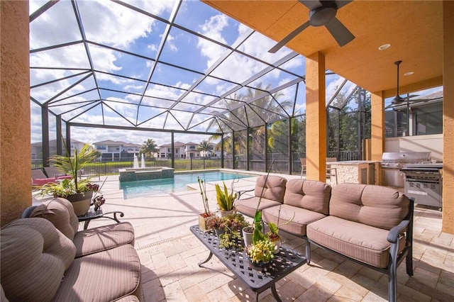 view of swimming pool with an outdoor kitchen, a lanai, and a patio