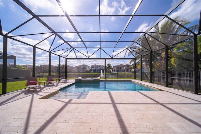 view of pool featuring a lanai, an in ground hot tub, and a patio