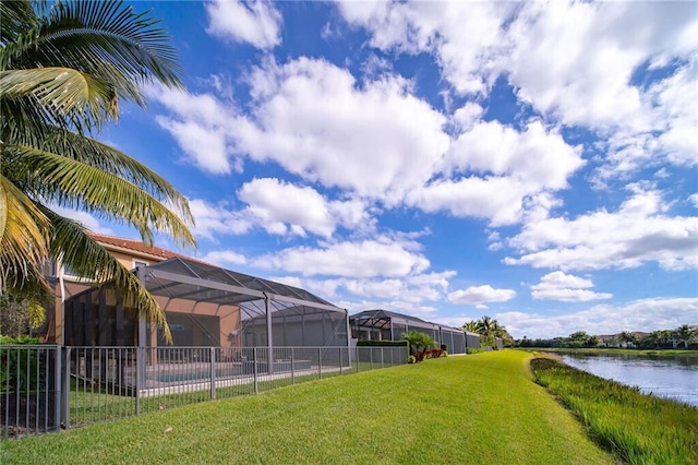 view of yard featuring a lanai and a water view